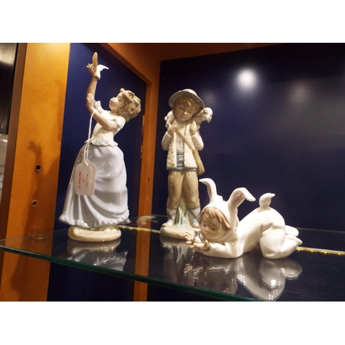 13 - Three Nao figurines 'Boy with Lamb', 'Girl with Dove' and 'Small Child with Bird'