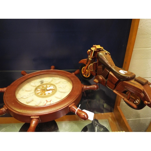 72 - A carved wooden motorcycle and a ships wheel clock