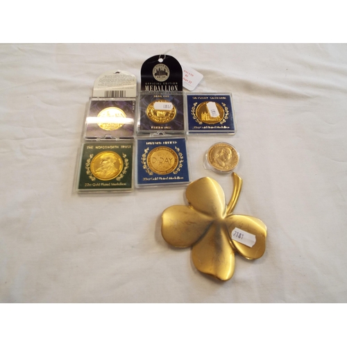 81 - A collection of six gold plated medallions and a clover