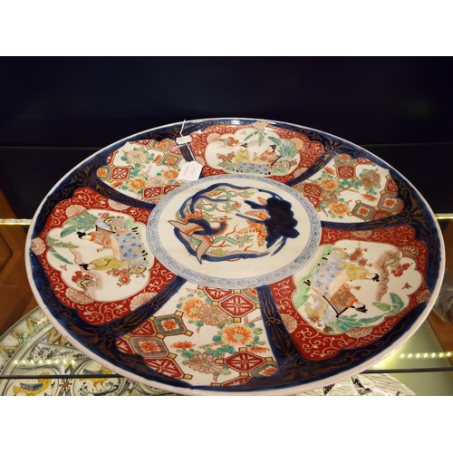 9 - A large Imari charger with figures, flowers etc