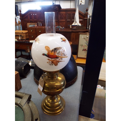 242 - A brass oil lamp with pheasant decoration with Opaline shade