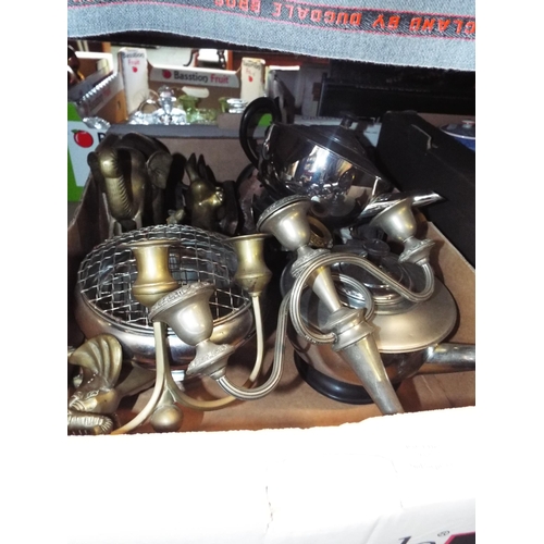 257 - A box of assorted metal ware to include brass elephant, plated candelabra