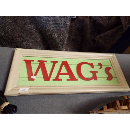 219 - A carved wooden sign 'WAGS'