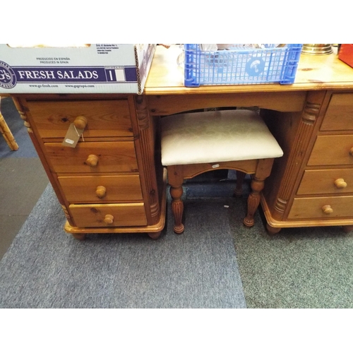 511 - A pine dressing table with eight short drawers and stool