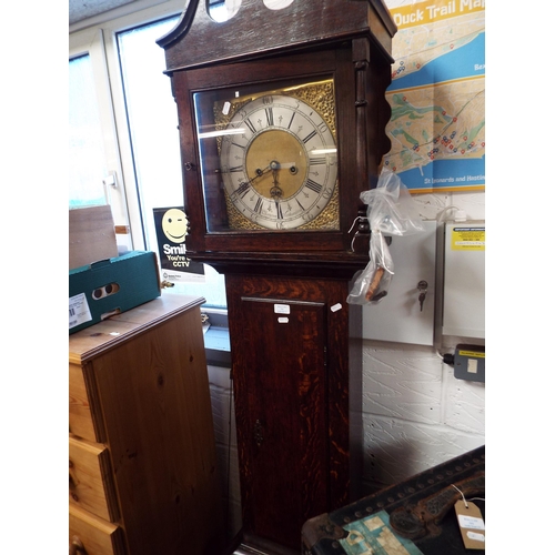 594 - An oak cased grandfather clock having brass and silvered dial with Roman numerals eight day movement... 