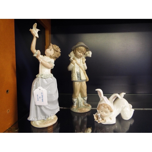 16 - Three Nao figurines 'Boy with Lamb', 'Girl with Dove' and 'Small Child with Bird'