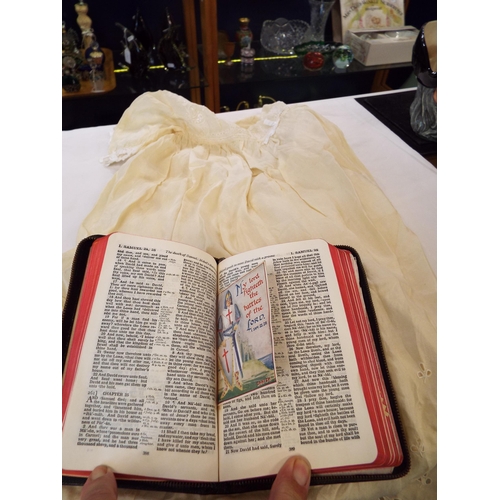 104 - A holy bible and a christening gown