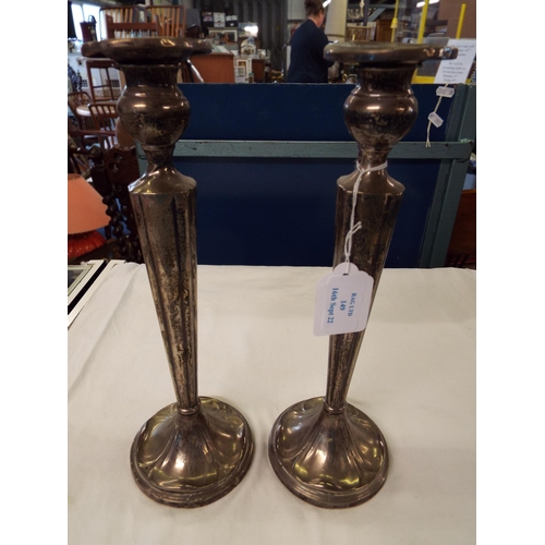 149 - A pair of sterling silver candlesticks of tapering form (loaded)