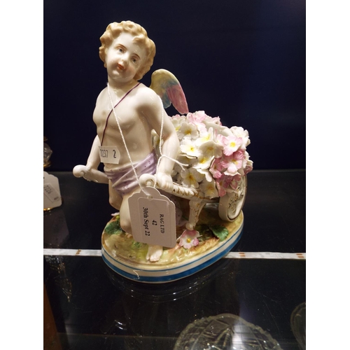 42 - A Continental porcelain bud vase with cherub and encrusted flowers