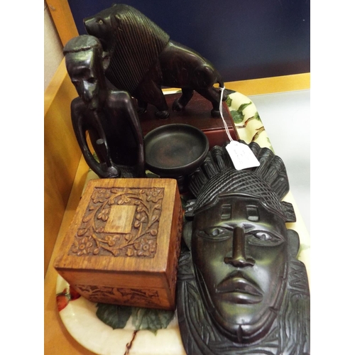 60 - A selection of carved ebony items to include lion, figure, mask and lidded pot