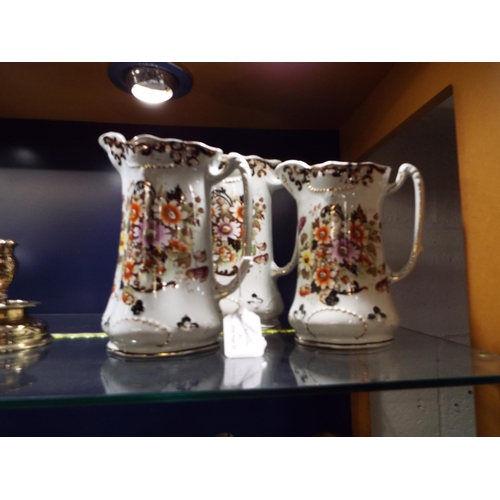 82 - A set of three graduating water jugs TR & C Hereford