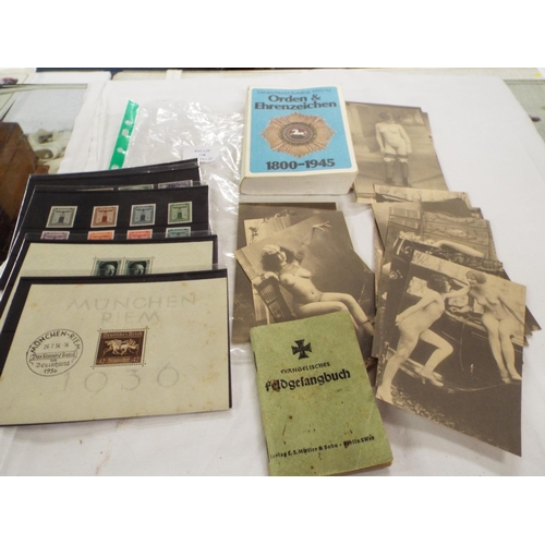 138 - A mixed selection of German Wartime ephemera to include stamps, explicit postcards, booklets