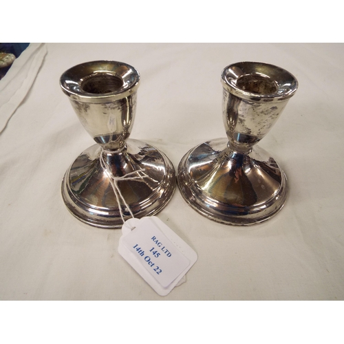 145 - A pair of sterling silver squat candlesticks (loaded)