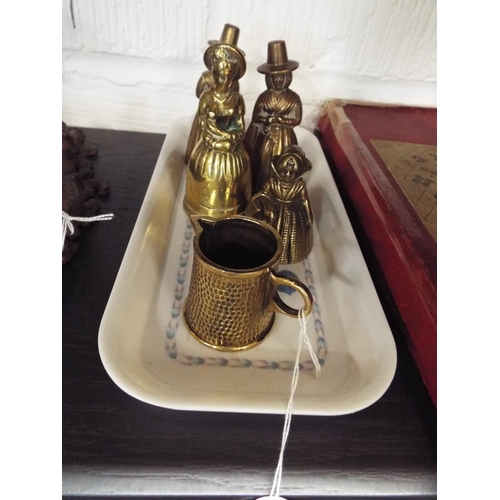 70 - A selection of brass lady bells and jug