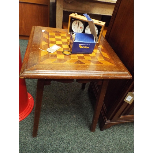 615 - A mahogany chess table, chess pieces and clock