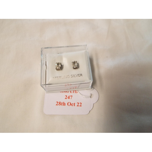 247 - A pair of sterling silver earrings inset with clear stones