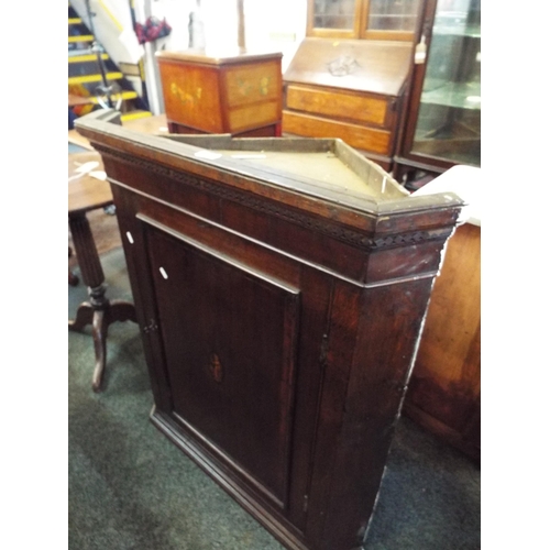 637 - A Georgian oak corner cupboard with inlaid panel