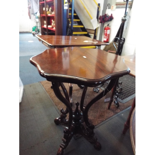 639 - A mahogany scallop shaped table with scroll work stretchers and supports