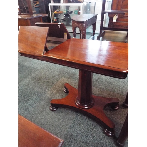 646 - An early Victorian mahogany music table having end hinged flaps with chamfered pedestal and quatrefo... 