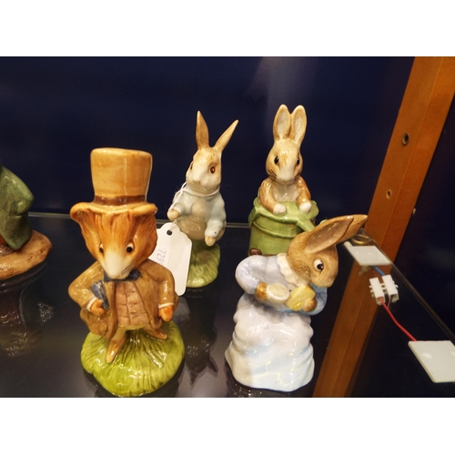 7 - Four Beswick Beatrix Potter figurines to include 'Amiable Guinea Pig', 'Peter in the Watering Can', ... 