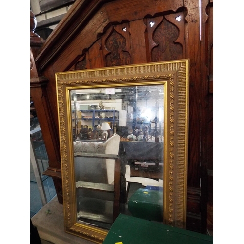 539 - An ornate gilt framed bevel glass mirror