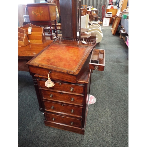 573 - A Victorian rosewood davenport having secret drawer, red leather writing slope on a swivel mount abo... 