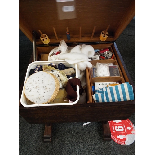 584 - An oak sewing table and contents