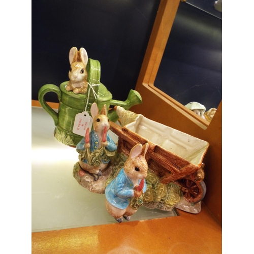 38 - Two Continental Beatrix Potter figures 'Peter in Watering Can' and 'Peter by the Wheelbarrow' and a ... 