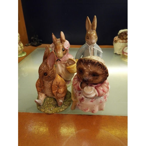 41 - Four Beswick Beatrix Potter figurines to include 'Peter Rabbit Digging', 'Mrs Rabbit', 'Mrs Tiggy Wi... 