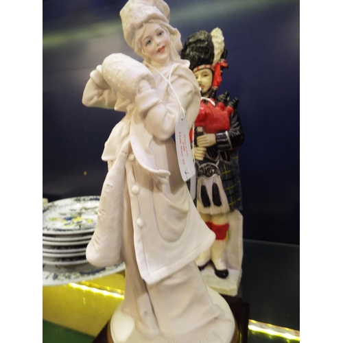 130 - A Capodimonte B. Merli figurine of a female in period costume and a resin figurine of a Scottish bag... 