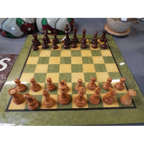 306 - A good weighted wooden chess set with a chess board