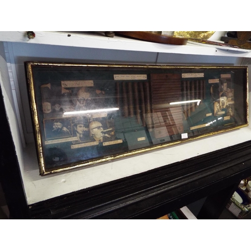 412 - A wooden display case housing advertising cigars and images of famous people smoking them