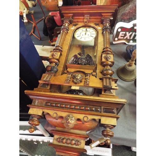 221 - A large Vienna wall clock having enamel dial Roman numerals set in ornate walnut case with Eagle ped... 