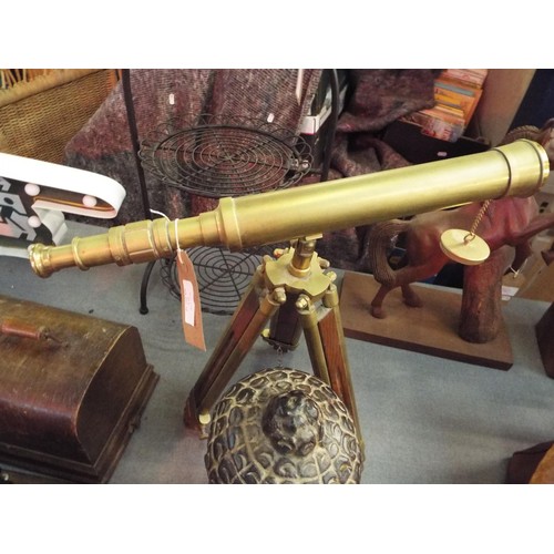 214 - A reproduction brass telescope with extending tri-pod