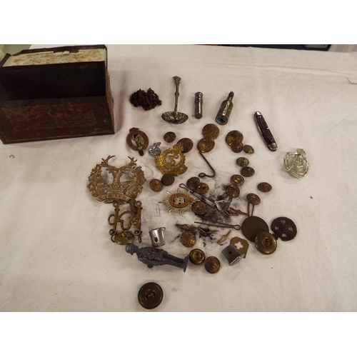 144 - A selection of military buttons, cap badges, penknives etc