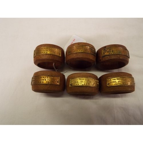 165 - A set of six teak napkin rings with H.M.S Iron Duke labels
