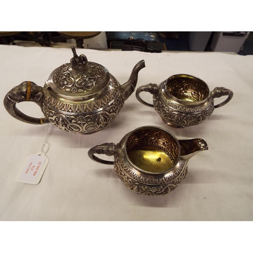 174 - A circa 1900 three piece Indian silver tea-set chased in high relief with deities in cartouche with ... 