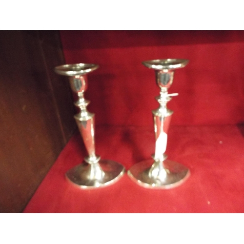 206 - A pair of slender silver-plated candlesticks