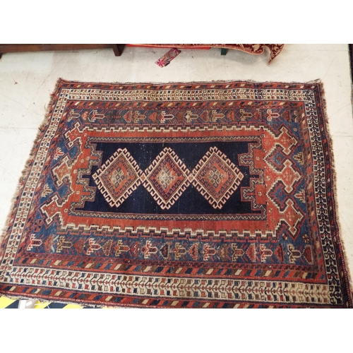 421 - A hand woven vintage blue and red ground rug 80