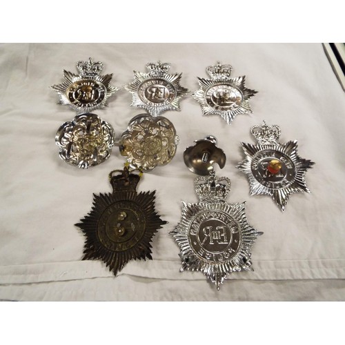 142 - A large selection of Police helmet badges, buttons, cloth insignia