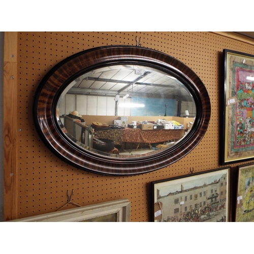 376 - A large oval framed mirror