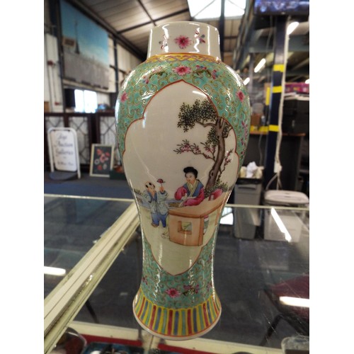 44 - A Chinese famille rose vase decorated with panels of figures and flowers, seal mark to base