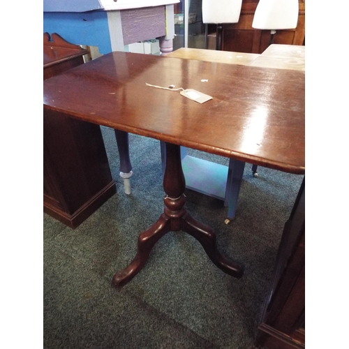 605 - A mahogany oblong snap top side table resting on tri-form base