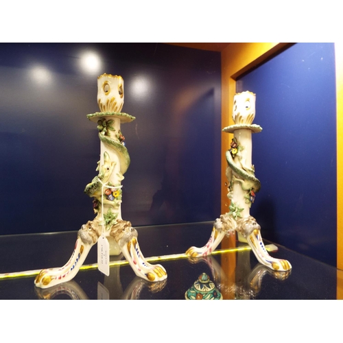 1 - A pair of porcelain candlesticks having raised Salamander and floral decoration A/F