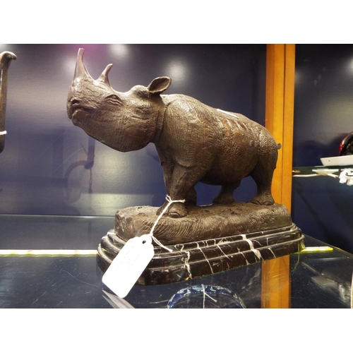 43 - A bronze sculpture of a Rhinoceros on a marble base (horn A/F) signed Julie Moigniez