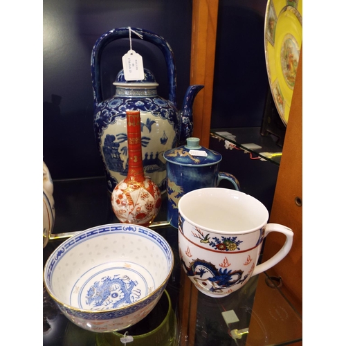 46 - A mixed selection of Oriental china to include teapot, lidded mug, vase, bowl etc