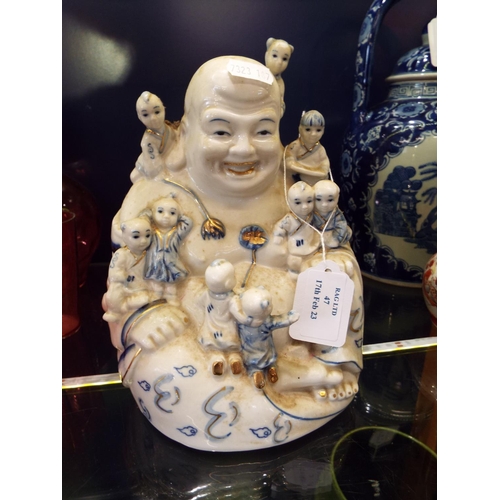 47 - A large Leonardo Collection blue and white Buddha and children