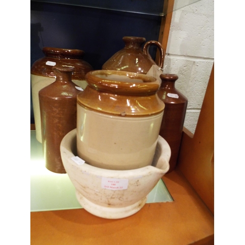 100 - A stoneware flagon, two stoneware bottles, two storage jars and a Wedgwood mortar