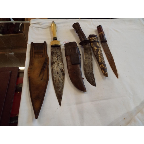 110 - Three Middle Eastern daggers one with bone handle