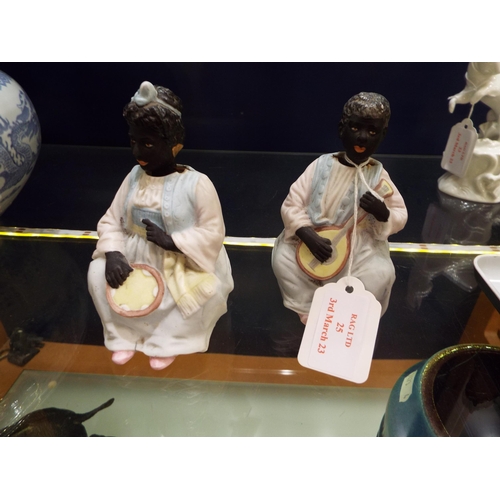 25 - A pair of ceramic nodding female figurines